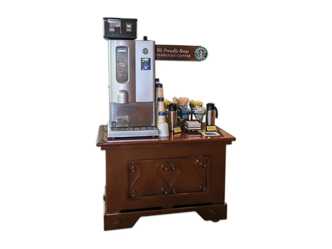 Mobile coffee cabinet with hinged doors and decorative wood finish supporting a coffee machine